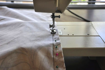 close up of sewing machine with curtains pinned