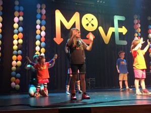 McLaine is on the left performing during vacation bible school on worship team