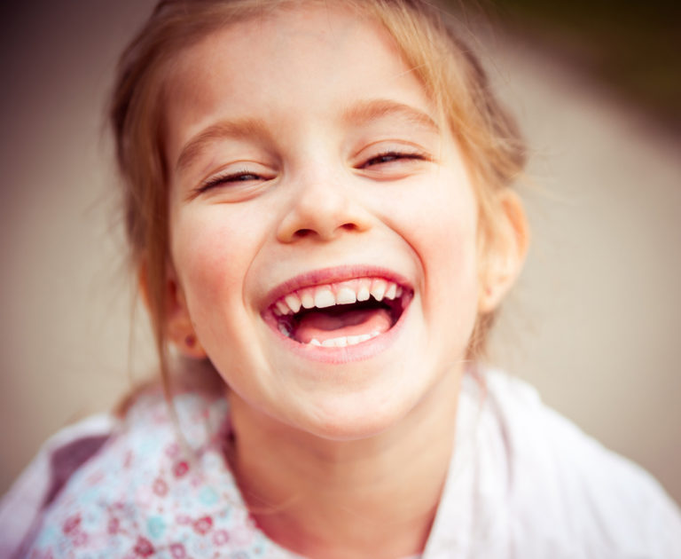 Little girl smiling, color photo