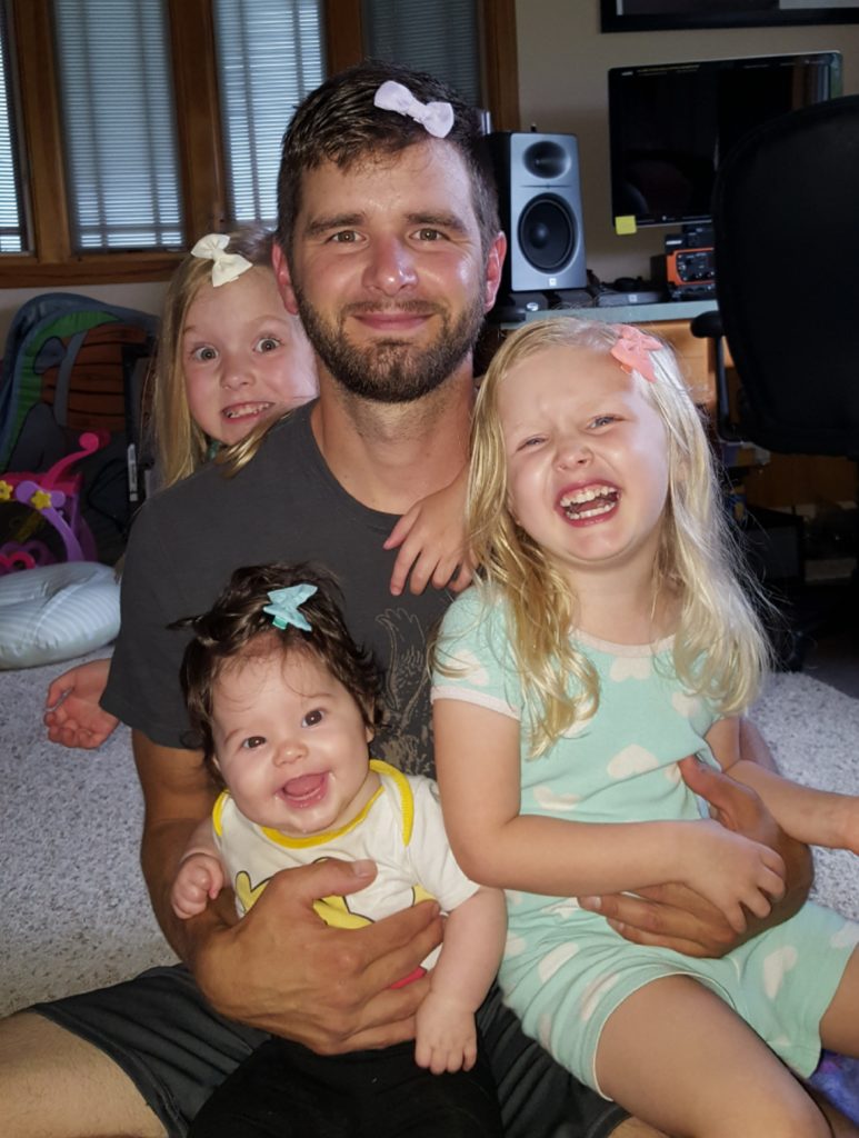 Dad with his three daughters and hair bows