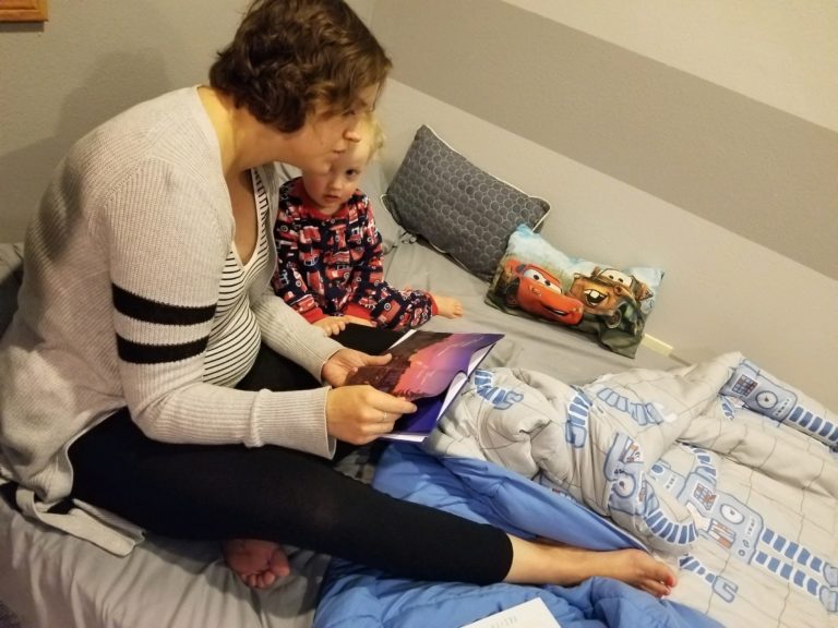 Mother reading a child a book at bedtime