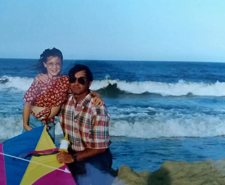 Father and daughter in vintage photo on the beach together