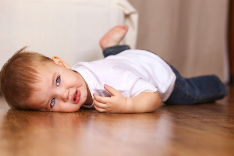 toddler throwing a tantrum on the floor