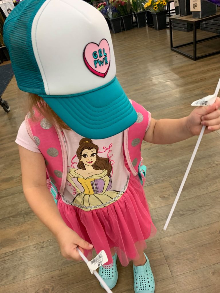 Toddler wearing a baseball cap and pink shirt