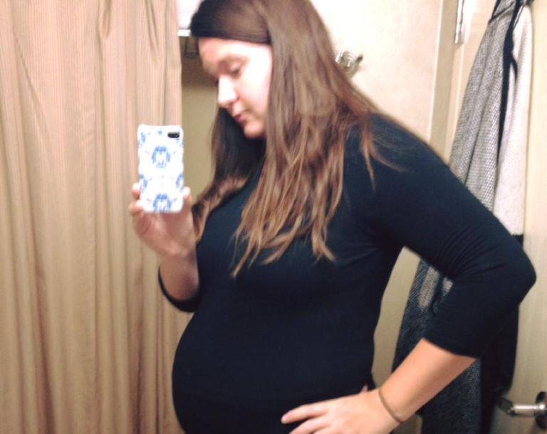 Pregnant woman taking photo of herself
