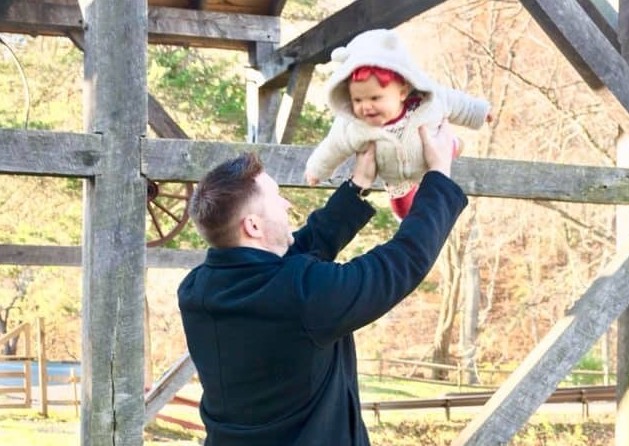 Daddy swinging his little girl in the air