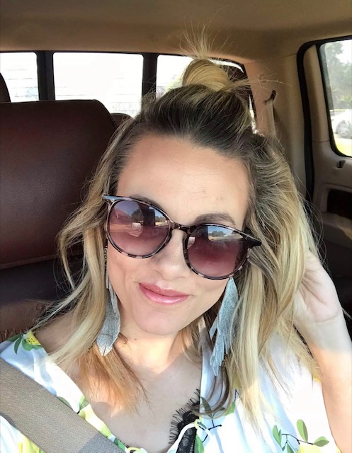Woman in sunglasses smiling in a selfie