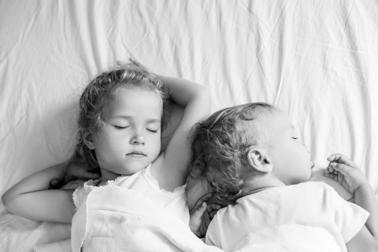 Two children sleeping in black and white photo