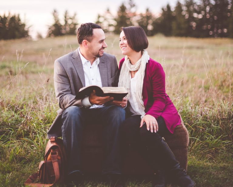 Pastor and wife sit outside and look at each other