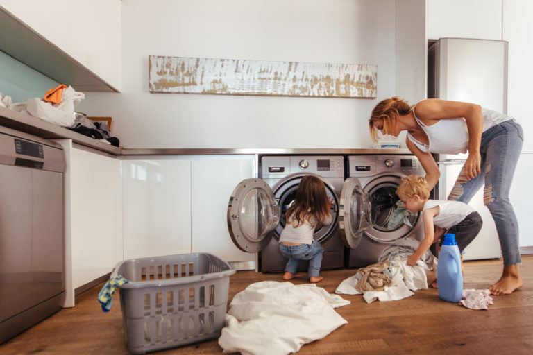 Mother and children doing laundry at home