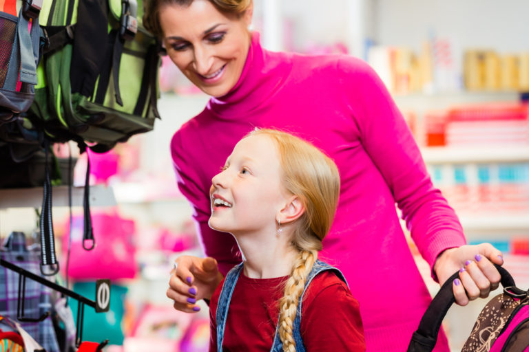 Mom and daughter shop for back to school backpack