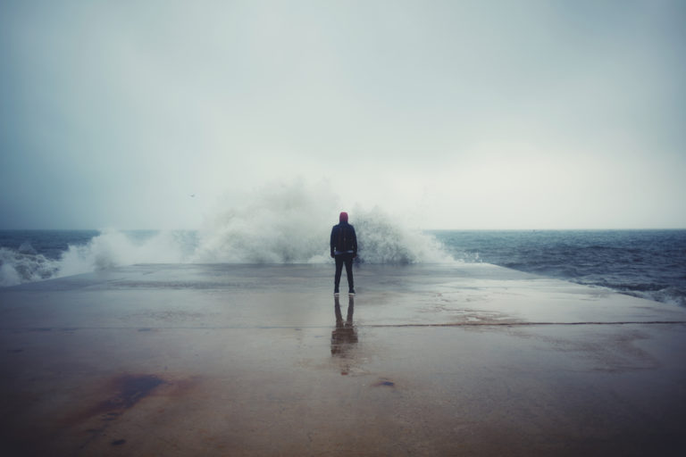 Person standing in front of wall of water