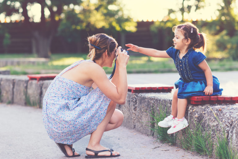 Mother taking photo of her daughter