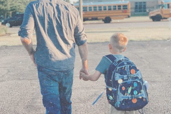 Little boy and father walk to school