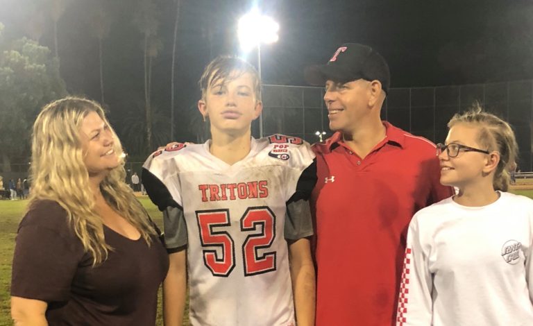Family with youth sports football player