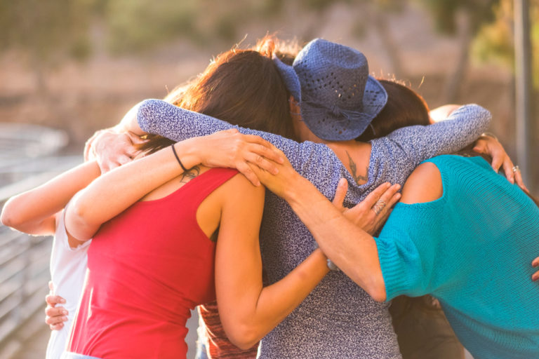 Group of women friends hugging