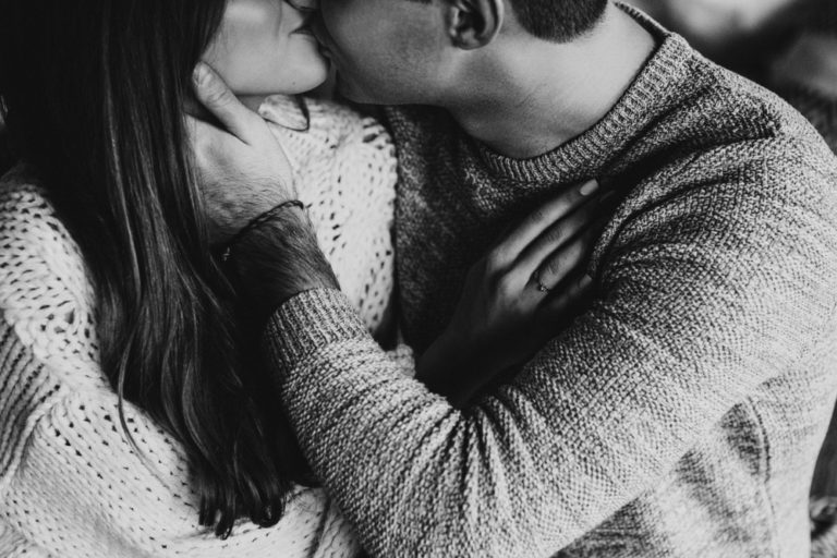 Husband kissing wife black and white photo