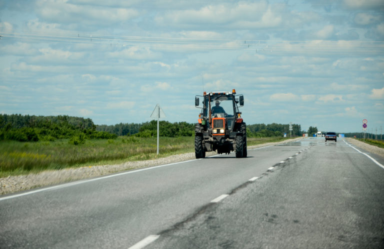 Tractor driving down the road