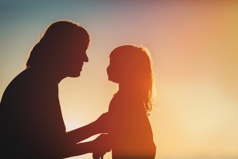 Silhouette of mother and daughter