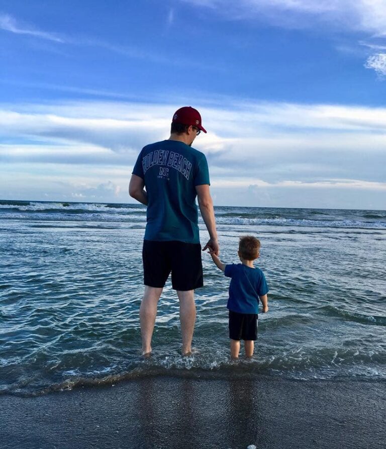 Father and son in waves