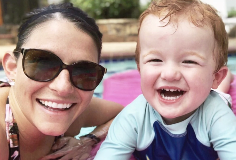 Mother and child smiling in pool