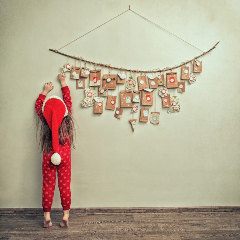 Child hanging up advent calendar
