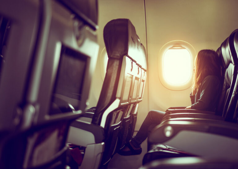 Woman looking out airline window