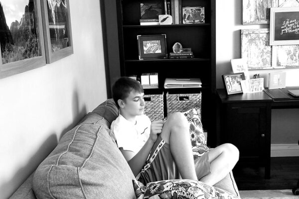 Teenage boy on couch with phone