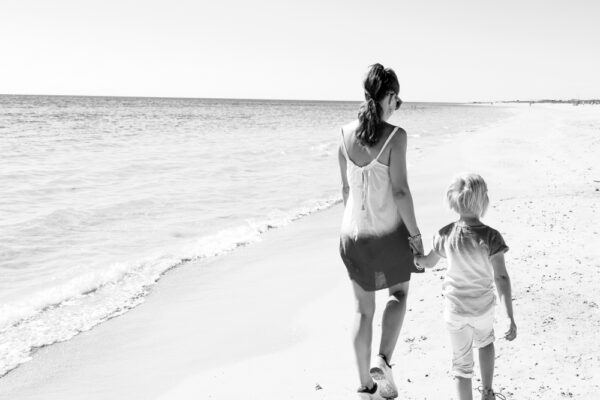 Mom and child walking on beach