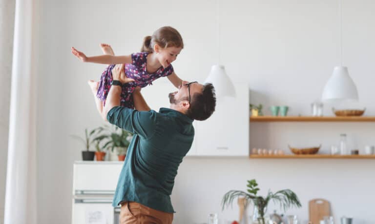 Dad lifting daughter in the air