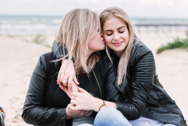 Mother and daughter at the beach hugging
