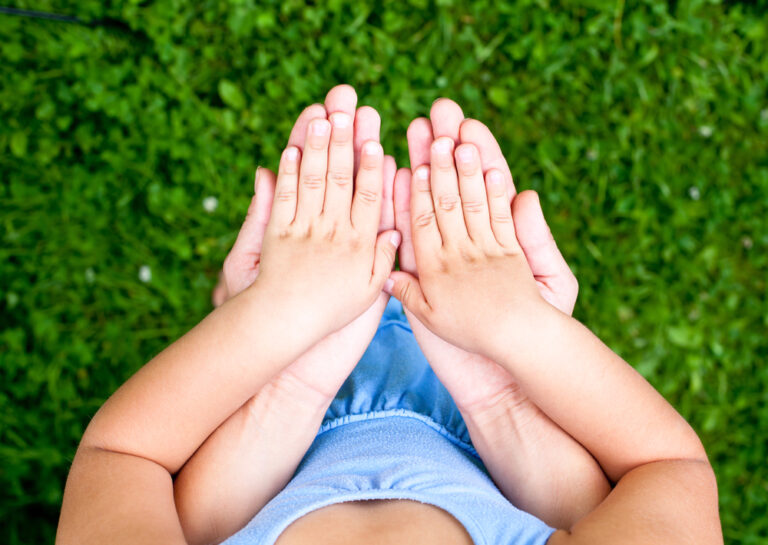 Child's hands in adult palms