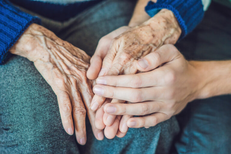 Elderly hands with young hands