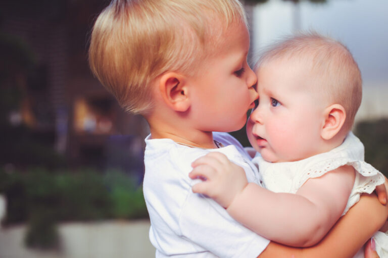Siblings brother and sister kissing