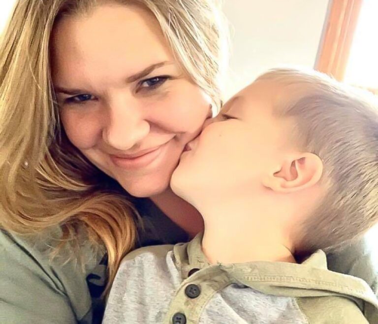 Toddler kissing mother on cheek