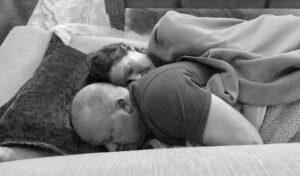 Husband and wife lying next to each other, black-and-white photo