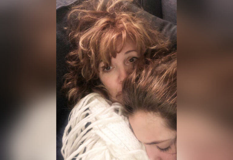 Teen sleeping on mother's shoulder