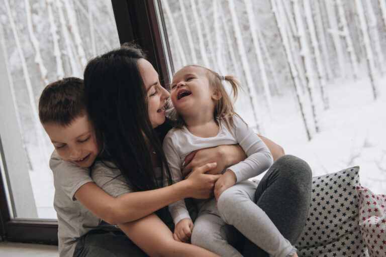 Mother with two children laughing together