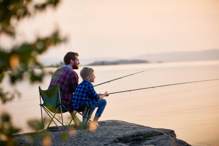 Father and son fishing on a dock