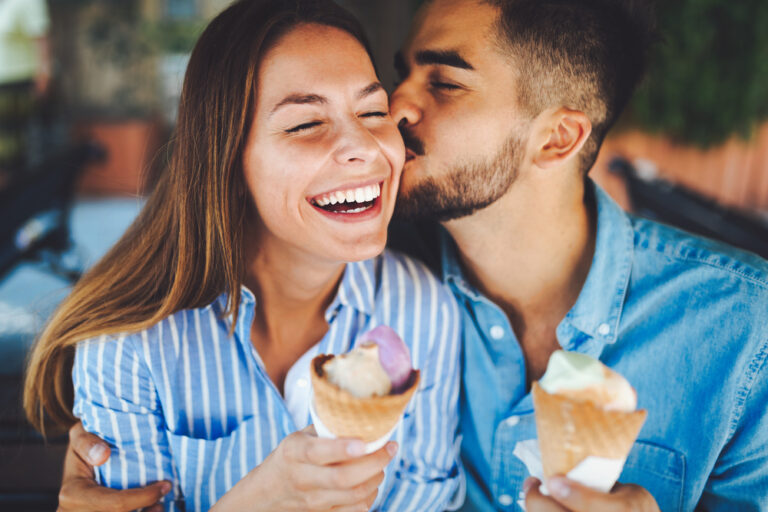 Husband and wife eating ice cream and laughing