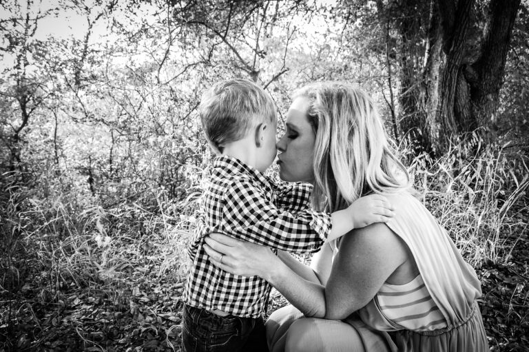 Mother kissing her little boy, black-and-white photo