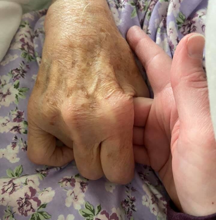 Holding elderly woman's hand