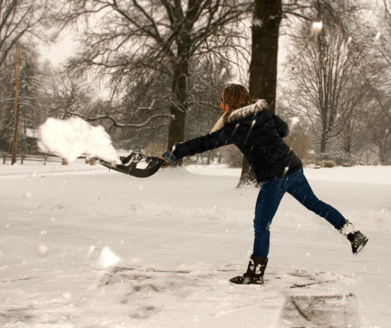 Woman shovels snow