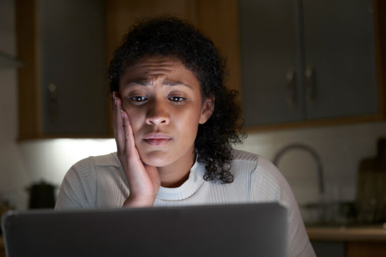 Worried woman late at night at computer