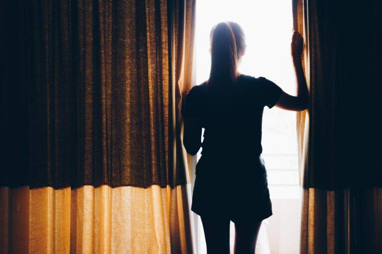 Woman looking out window silhouette