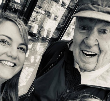 Selfie of older man and young woman in grocery store