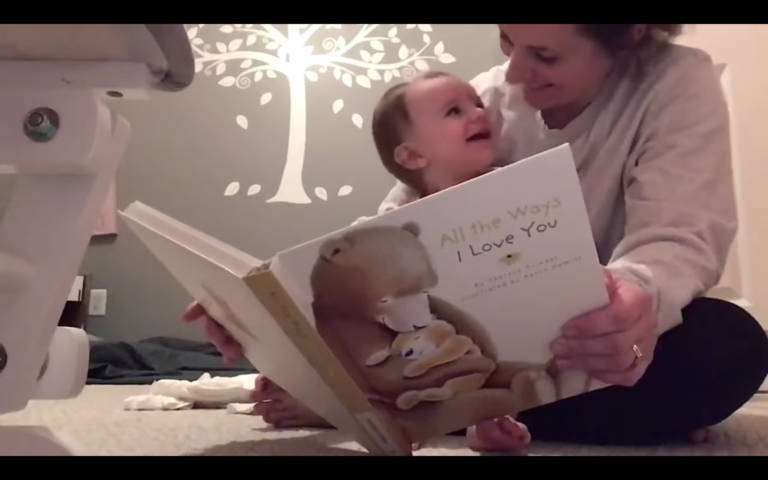 Mother reading a book to baby