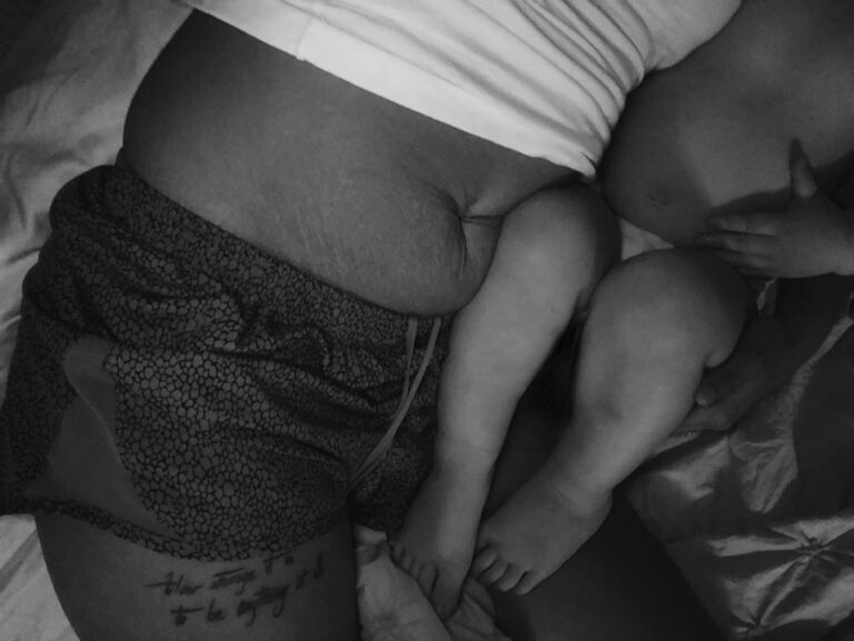 Black and white photo of baby legs and stomach