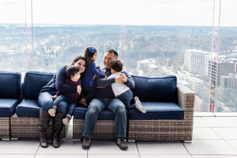 Fun picture of family of five on couch, color photo