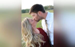 Man and woman kissing outside